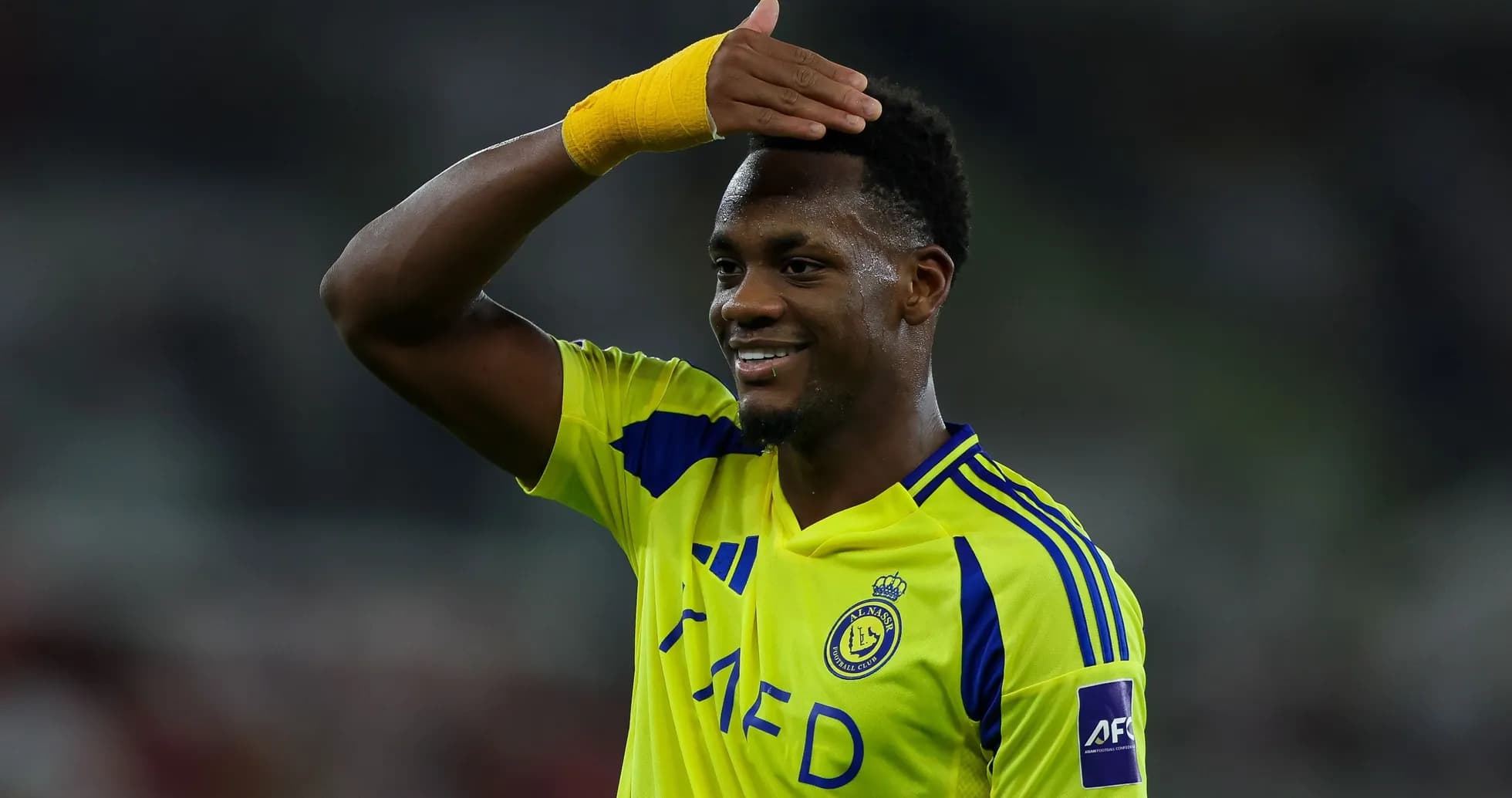 Player celebrating with a hand salute gesture Player celebrating with a hand salute gesture