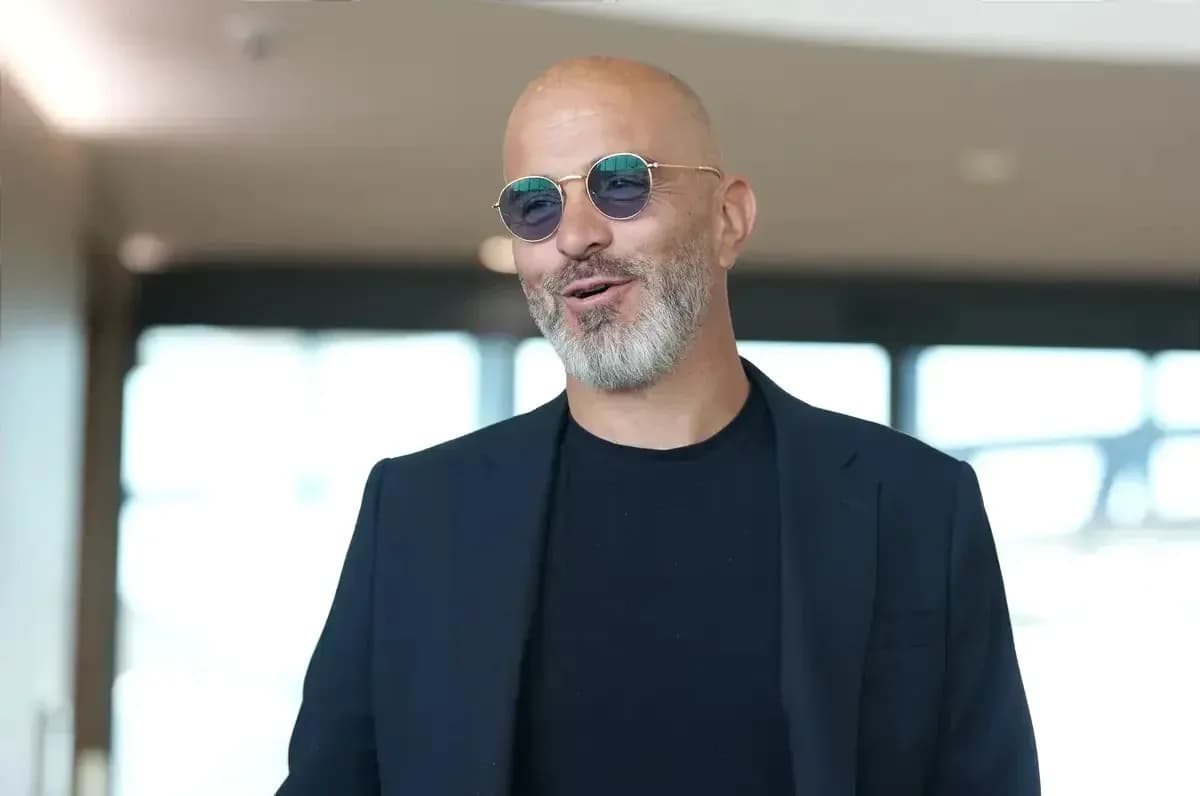 Man in sunglasses smiling in indoor setting Man in sunglasses smiling in indoor setting