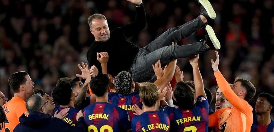 Barcelona team celebrating by lifting their coach Barcelona team celebrating by lifting their coach