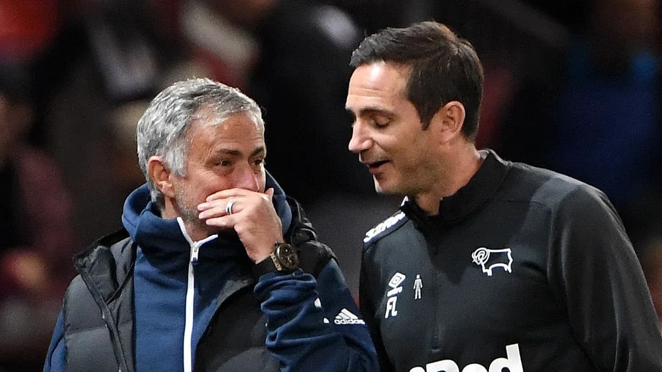 Two football managers talking on the sidelines Two football managers talking on the sidelines