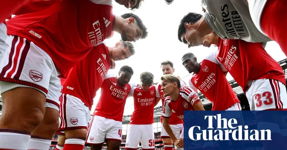 Arsenal players huddled together before a match Arsenal players huddled together before a match