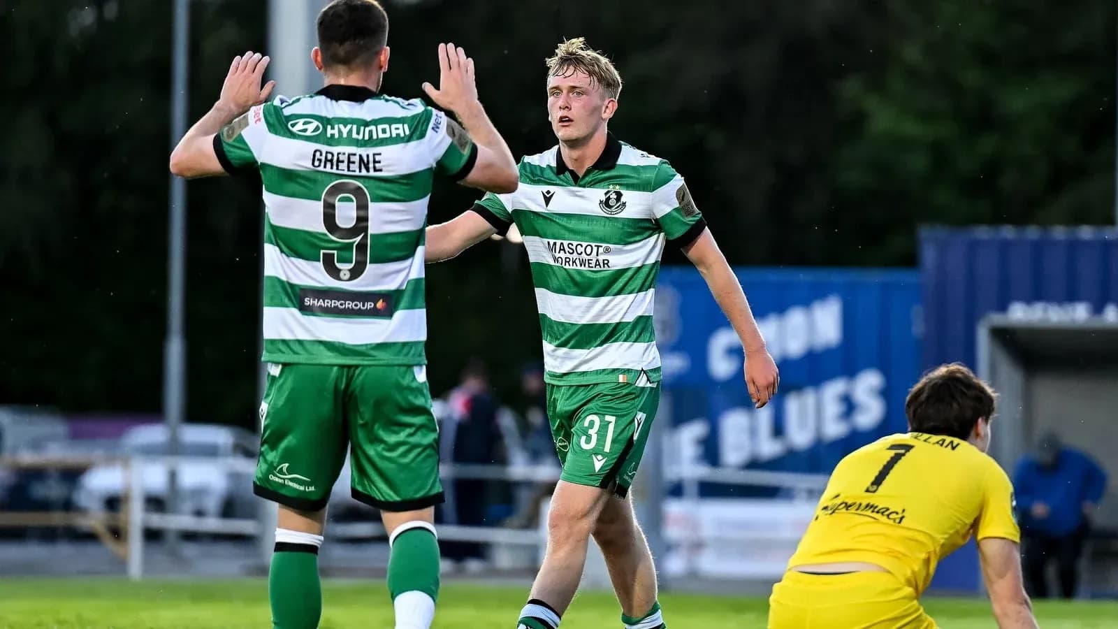 Two players celebrating a goal on the pitch Two players celebrating a goal on the pitch