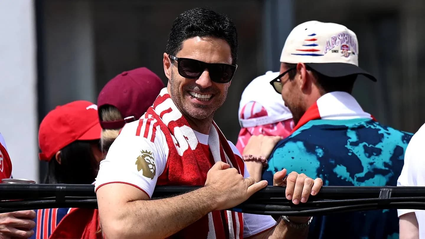 Man in sunglasses smiling with Arsenal scarf Man in sunglasses smiling with Arsenal scarf