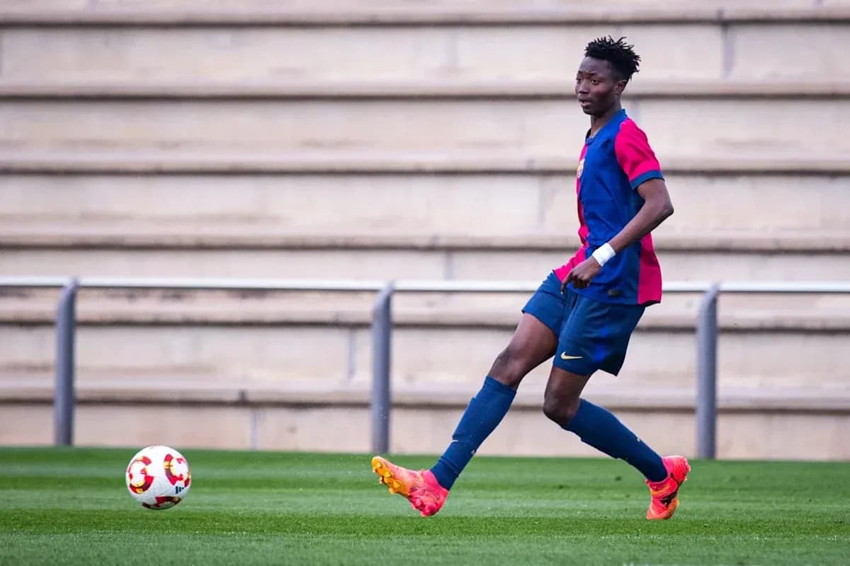 Player in FC Barcelona kit dribbling ball on field Player in FC Barcelona kit dribbling ball on field