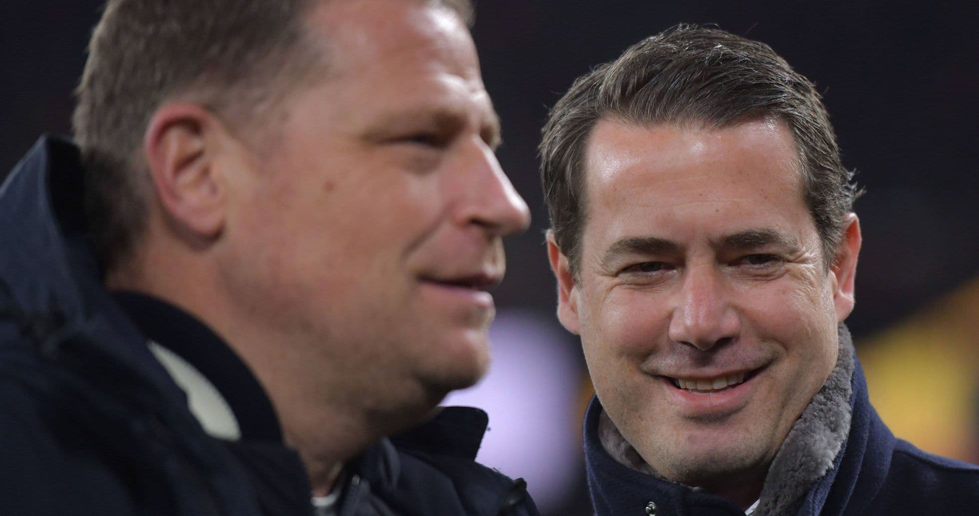 Two men talking on the sidelines of a match Two men talking on the sidelines of a match