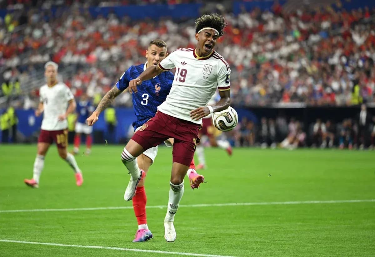 Player from Spain evading tackle by French defender Player from Spain evading tackle by French defender