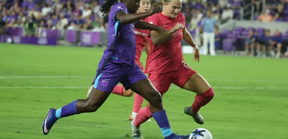 Orlando Pride player dribbling the ball against Boston Legacy Orlando Pride player dribbling the ball against Boston Legacy