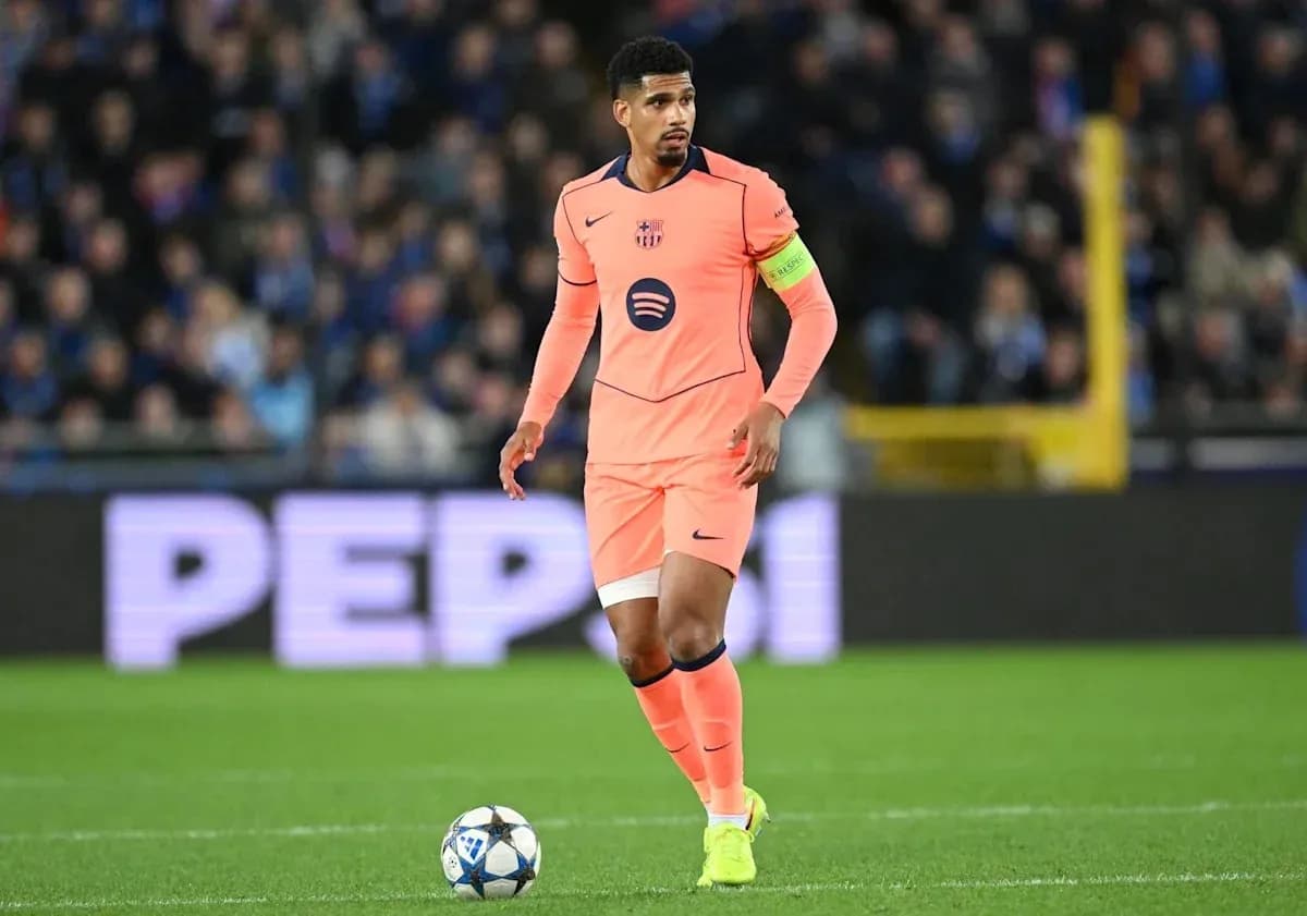 Player in pink kit dribbling ball on pitch Player in pink kit dribbling ball on pitch
