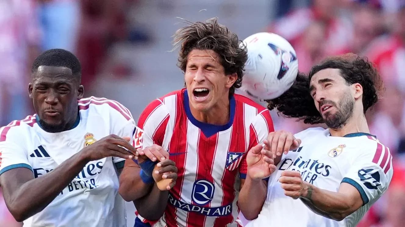 Players colliding while contesting for the ball Players colliding while contesting for the ball