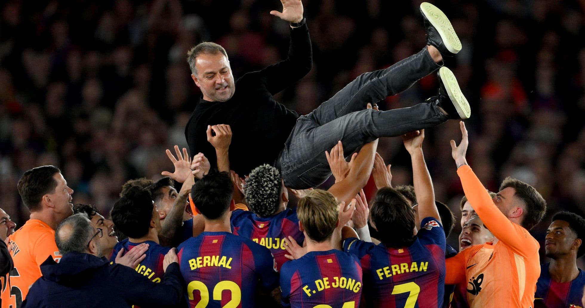 Barcelona players celebrating by lifting their coach Barcelona players celebrating by lifting their coach