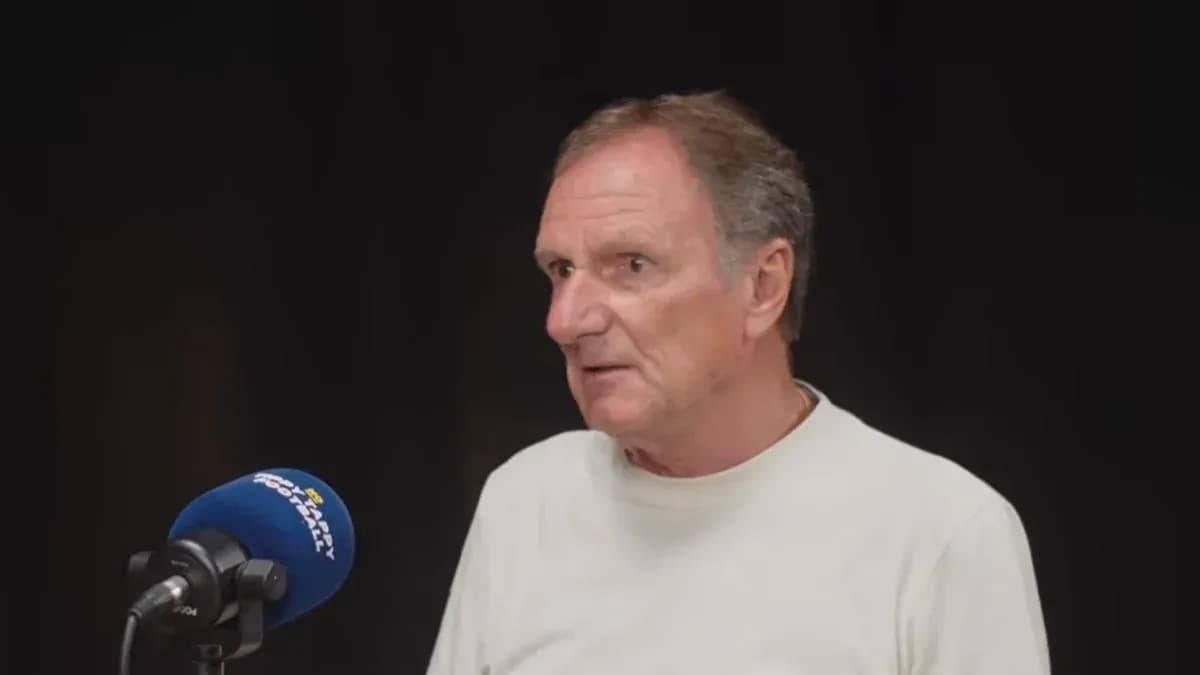 Man speaking at a microphone in studio setting Man speaking at a microphone in studio setting