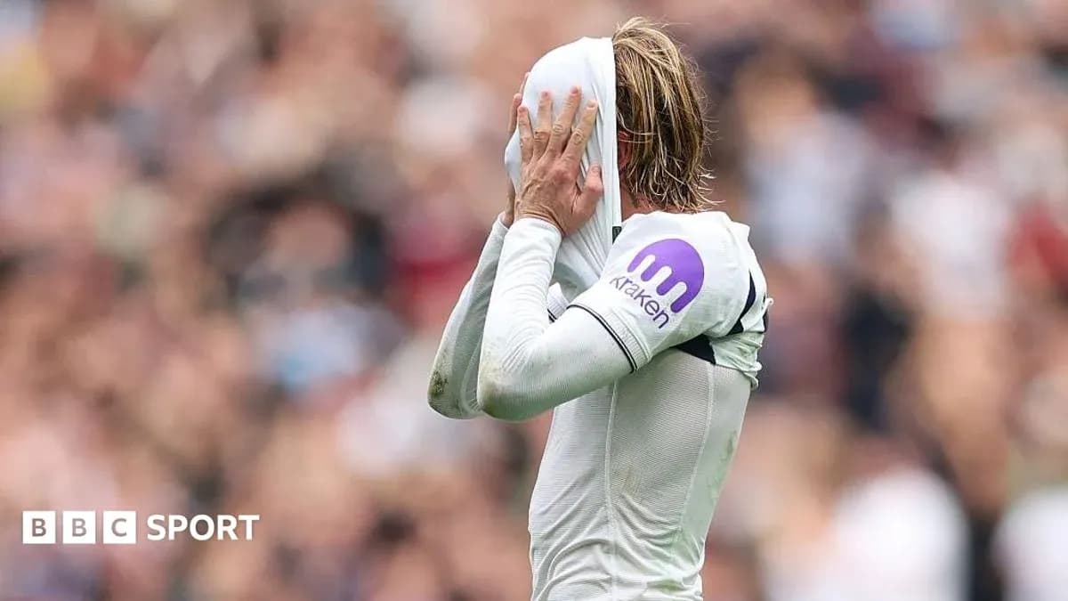 Player covering face with jersey during match Player covering face with jersey during match
