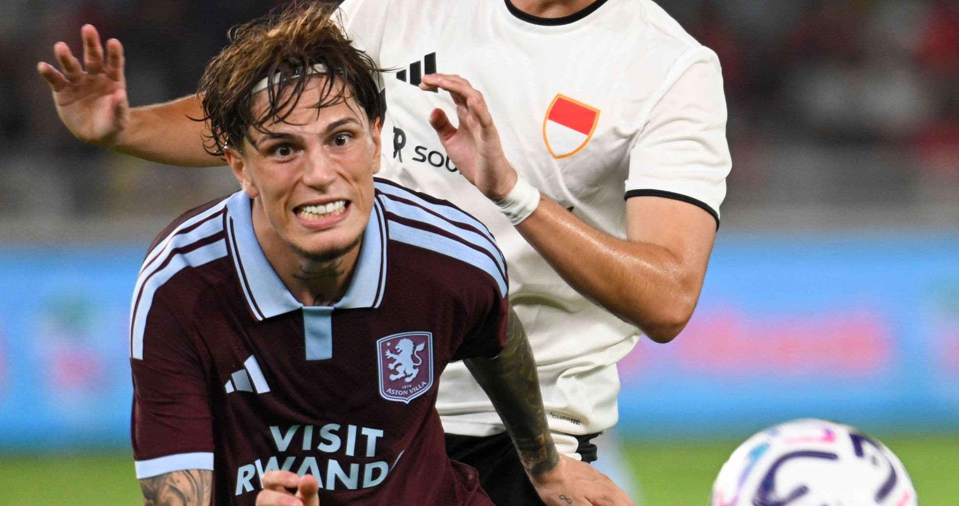 Player from Aston Villa being challenged during match Player from Aston Villa being challenged during match