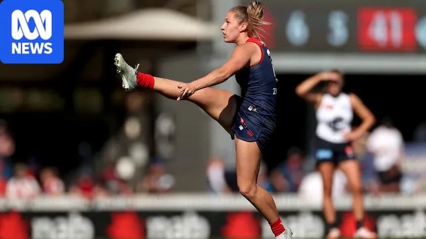 Player kicking ball during Australian rules football match Player kicking ball during Australian rules football match