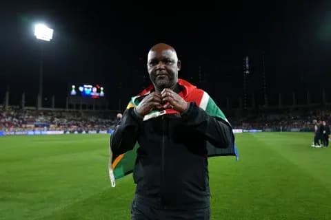 Coach holding South African flag on the field Coach holding South African flag on the field