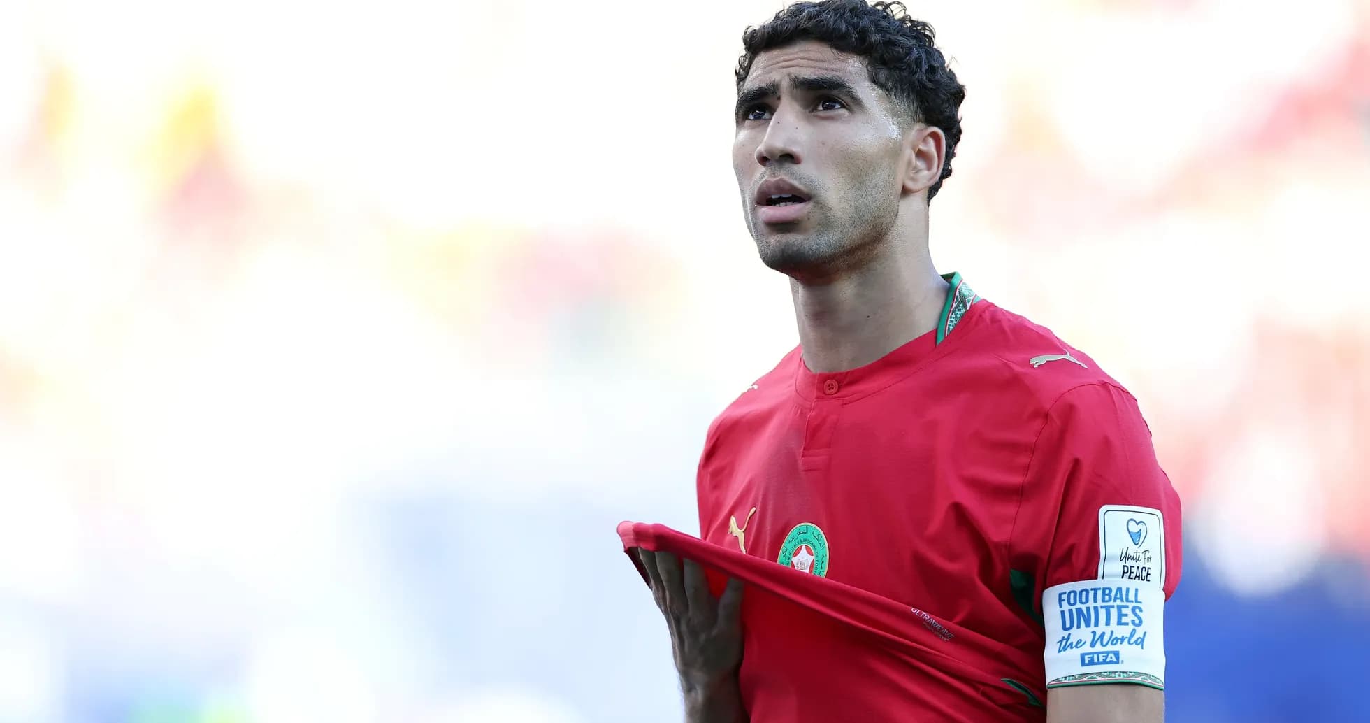 Player in red jersey holding shirt during match Player in red jersey holding shirt during match