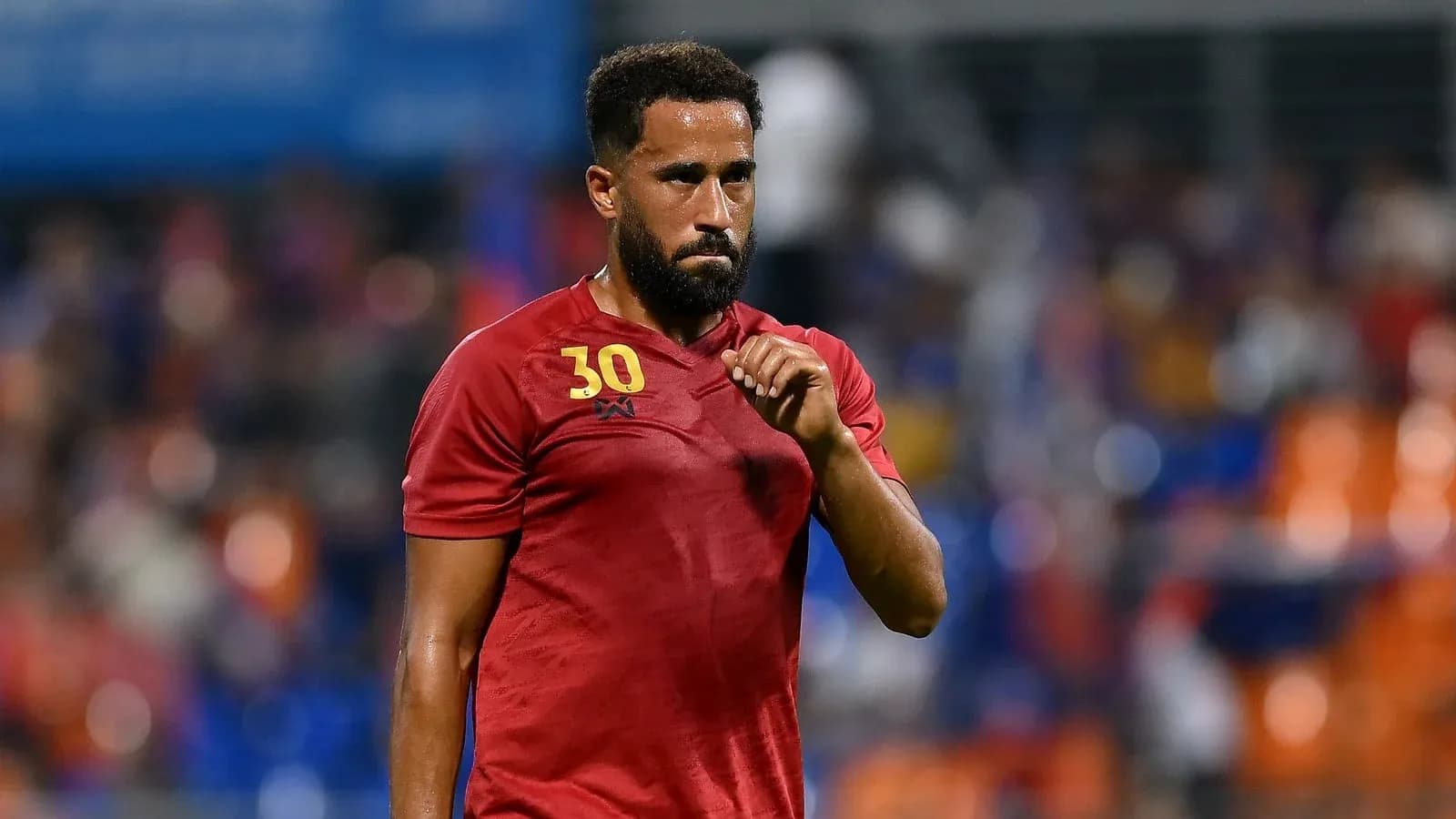 Player in red jersey gesturing during match Player in red jersey gesturing during match