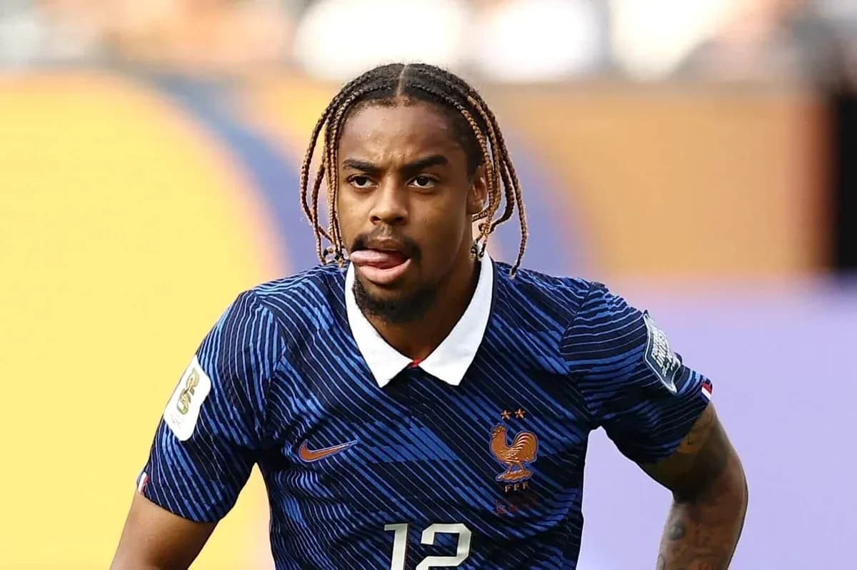 Player in France jersey running on the field Player in France jersey running on the field