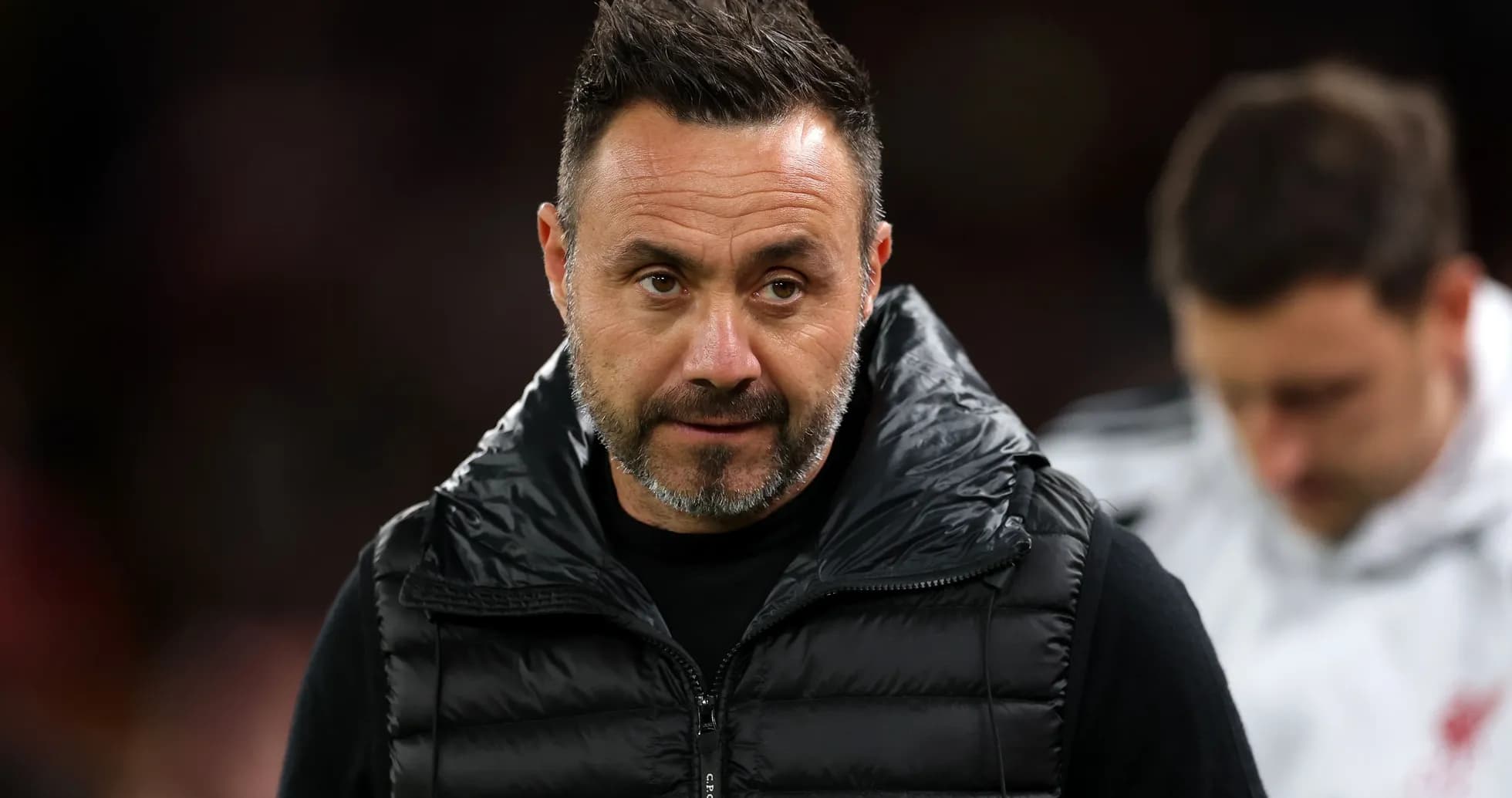 Coach in a puffer vest during match Coach in a puffer vest during match