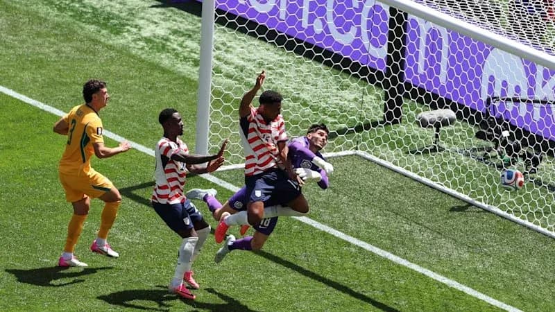 Players competing for a goal during a match Players competing for a goal during a match