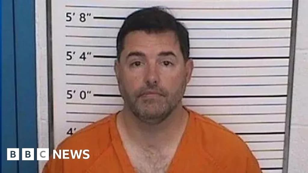 Man in orange jumpsuit at police mugshot backdrop Man in orange jumpsuit at police mugshot backdrop