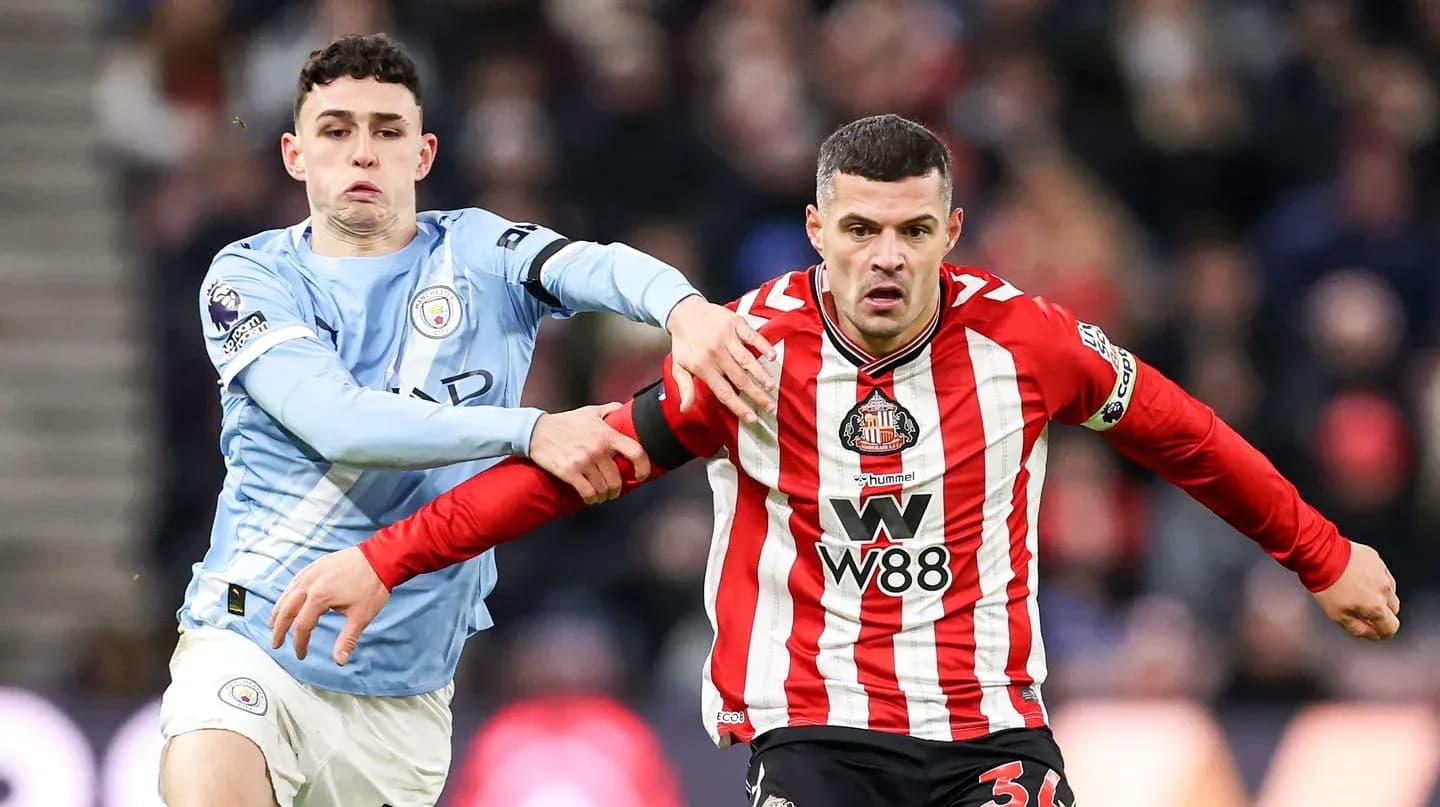 Phil Foden challenging Sunderland player during match Phil Foden challenging Sunderland player during match