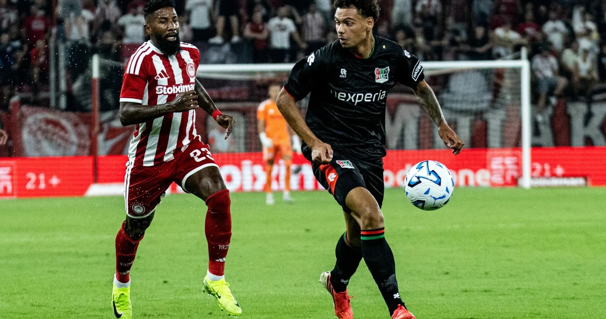 NEC Nijmegen player dribbling past Olympiakos defender NEC Nijmegen player dribbling past Olympiakos defender