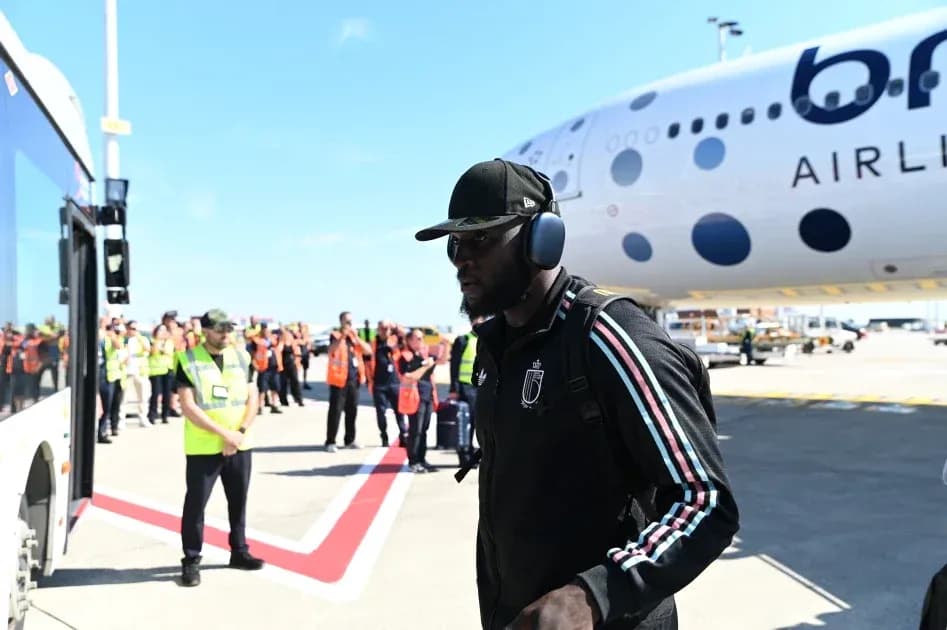 Player arriving at airport near airplane and staff Player arriving at airport near airplane and staff
