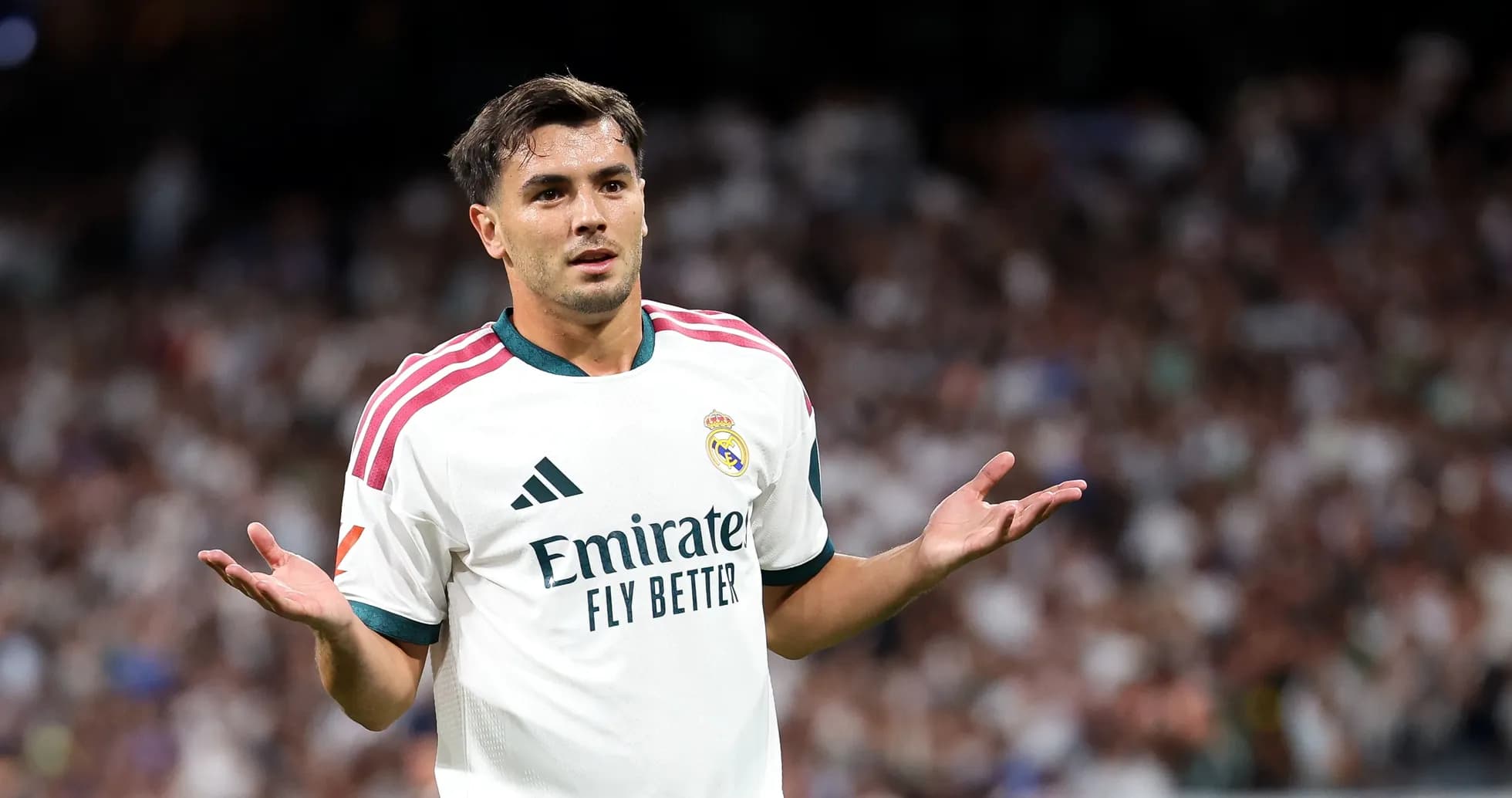 Player gesturing during match with crowd in background Player gesturing during match with crowd in background