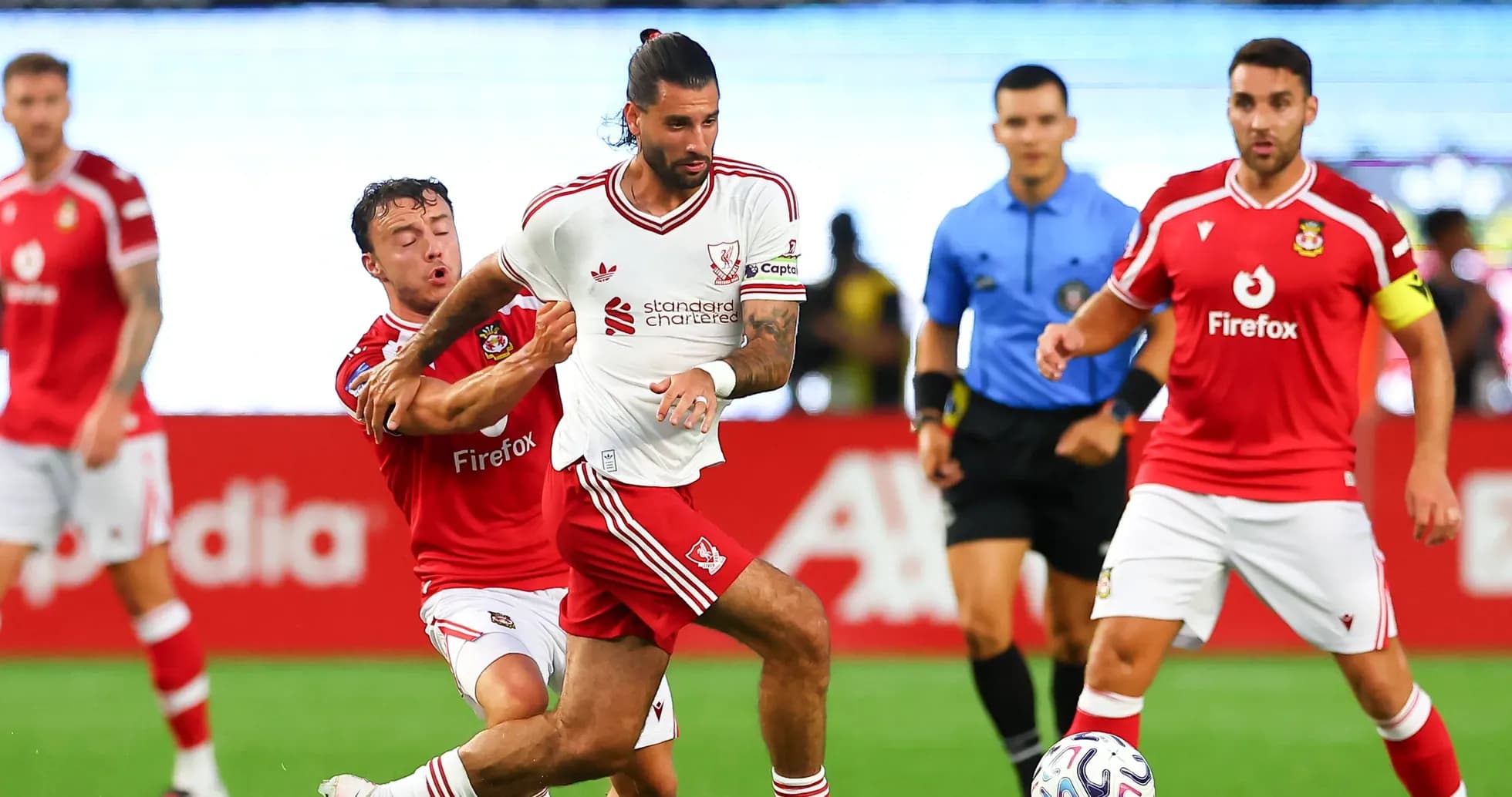 Player wearing white jersey being challenged by opponent Player wearing white jersey being challenged by opponent