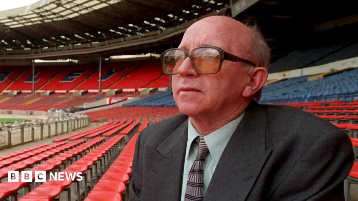 Man seated in empty stadium with red seats Man seated in empty stadium with red seats