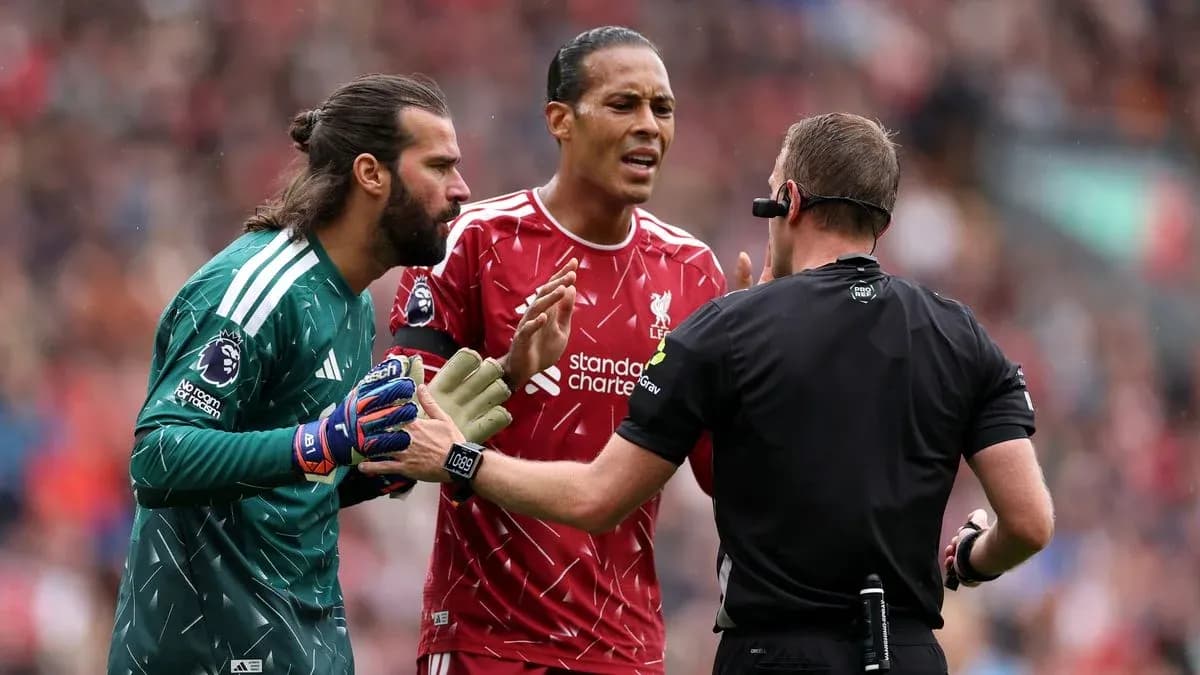 Goalkeeper and defender discussing with referee during match Goalkeeper and defender discussing with referee during match