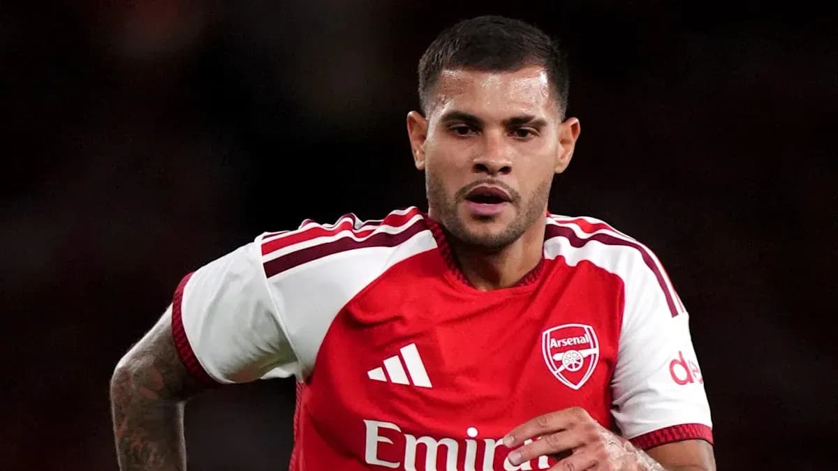 Player running during a match in Arsenal kit Player running during a match in Arsenal kit