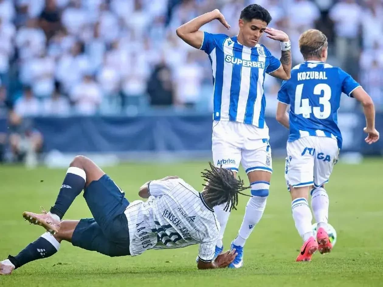 Lech Poznan player evades Aarhus defender Lech Poznan player evades Aarhus defender