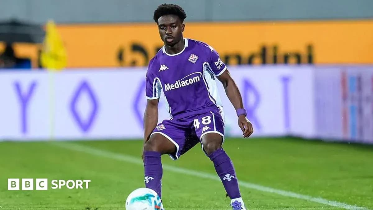 Player in purple kit preparing for play on field Player in purple kit preparing for play on field