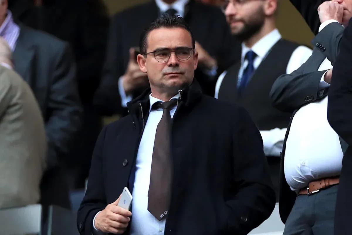 Man in formal attire observing from the stands Man in formal attire observing from the stands