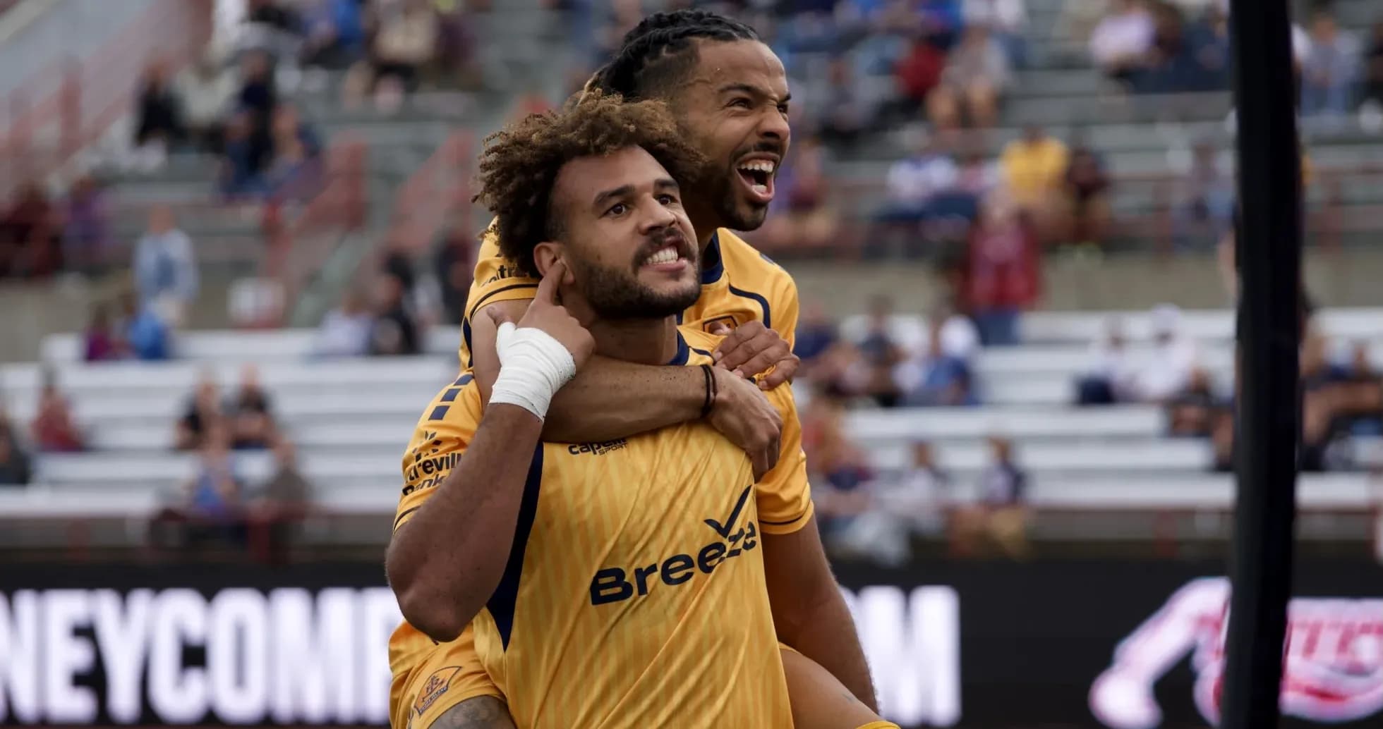 Two players celebrating a goal during match Two players celebrating a goal during match