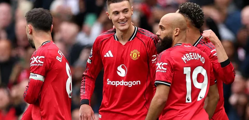 Manchester United players celebrating a goal together Manchester United players celebrating a goal together