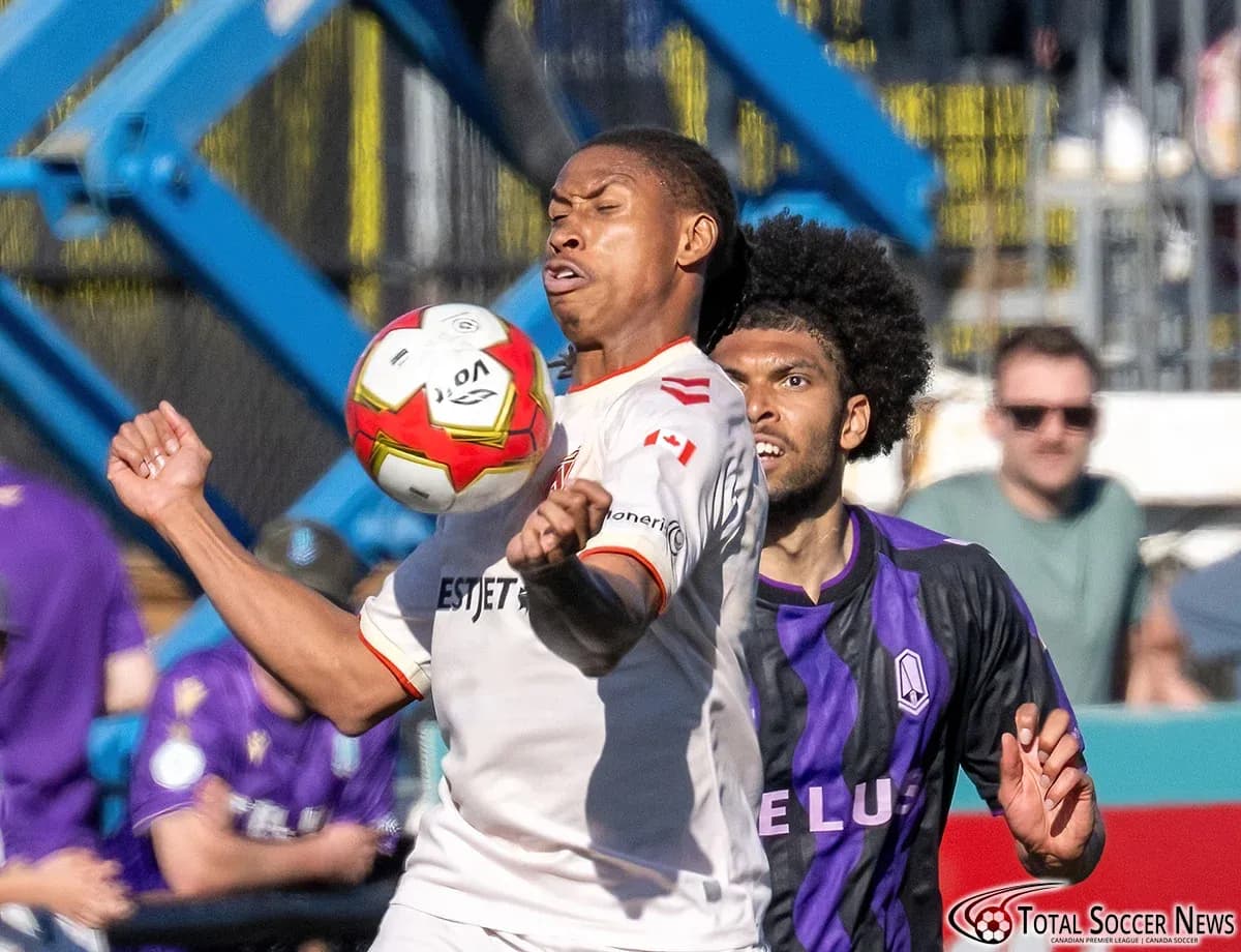 Cavalry FC player contests ball against Pacific FC opponent Cavalry FC player contests ball against Pacific FC opponent