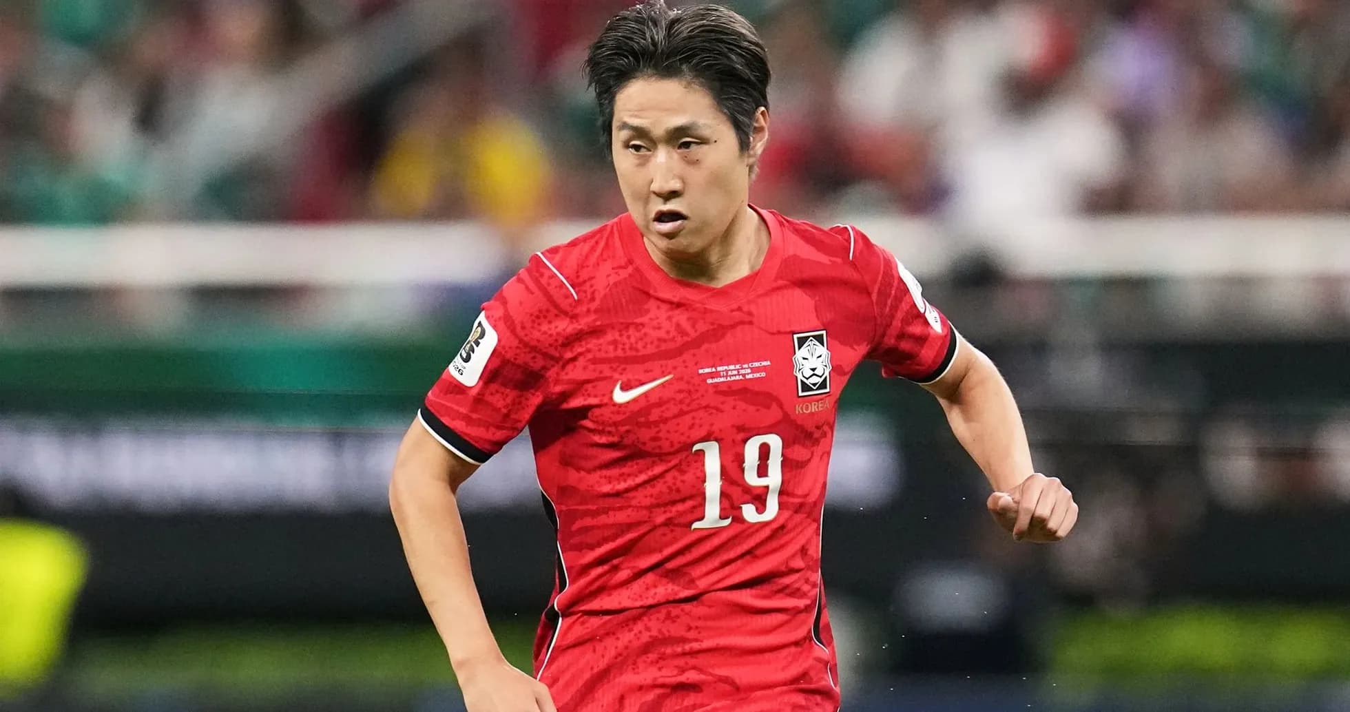 Player in red jersey running during match Player in red jersey running during match