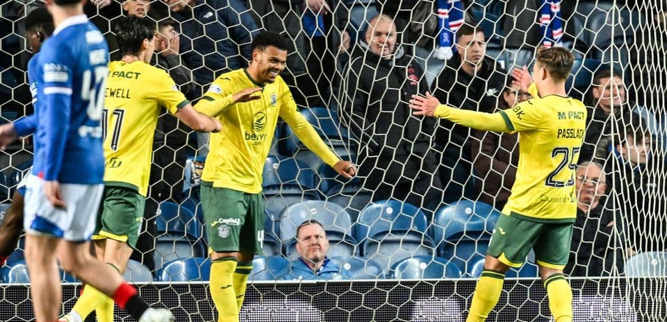 Players celebrating a goal in front of fans Players celebrating a goal in front of fans