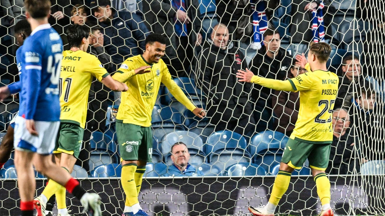 Players celebrating a goal in front of fans Players celebrating a goal in front of fans