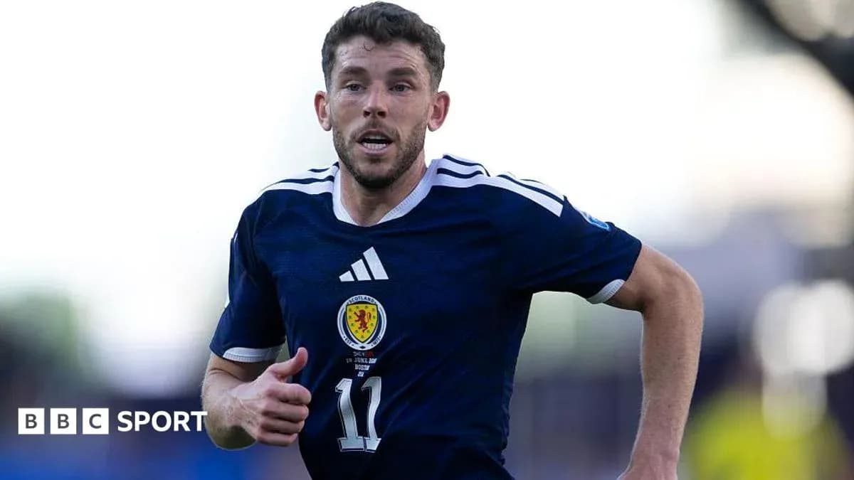 Player running during a football match for Scotland Player running during a football match for Scotland
