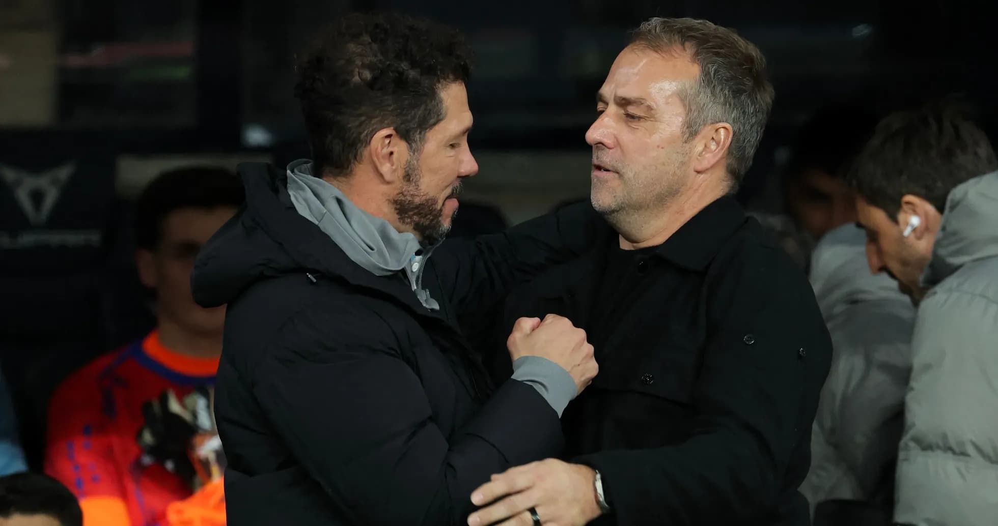 Two coaches embracing on the sidelines Two coaches embracing on the sidelines