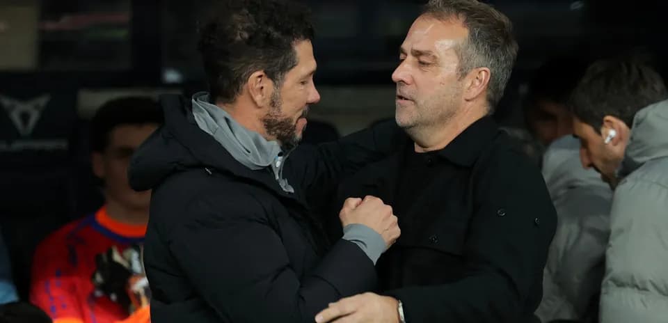 Two coaches embracing on the sidelines Two coaches embracing on the sidelines