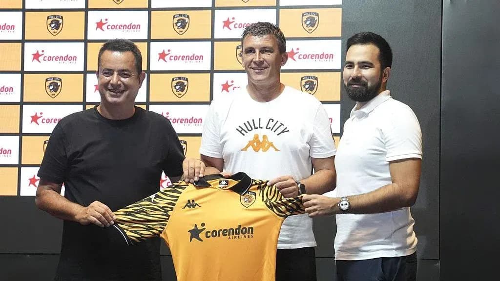 New coach holding Hull City jersey at announcement New coach holding Hull City jersey at announcement