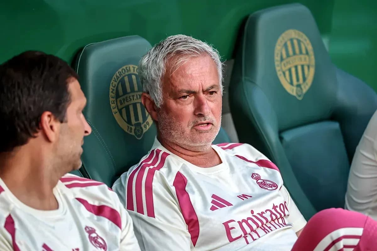 Manager and player seated on team bench Manager and player seated on team bench