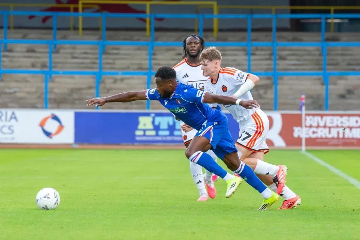 Player tackling opponent during a football match Player tackling opponent during a football match