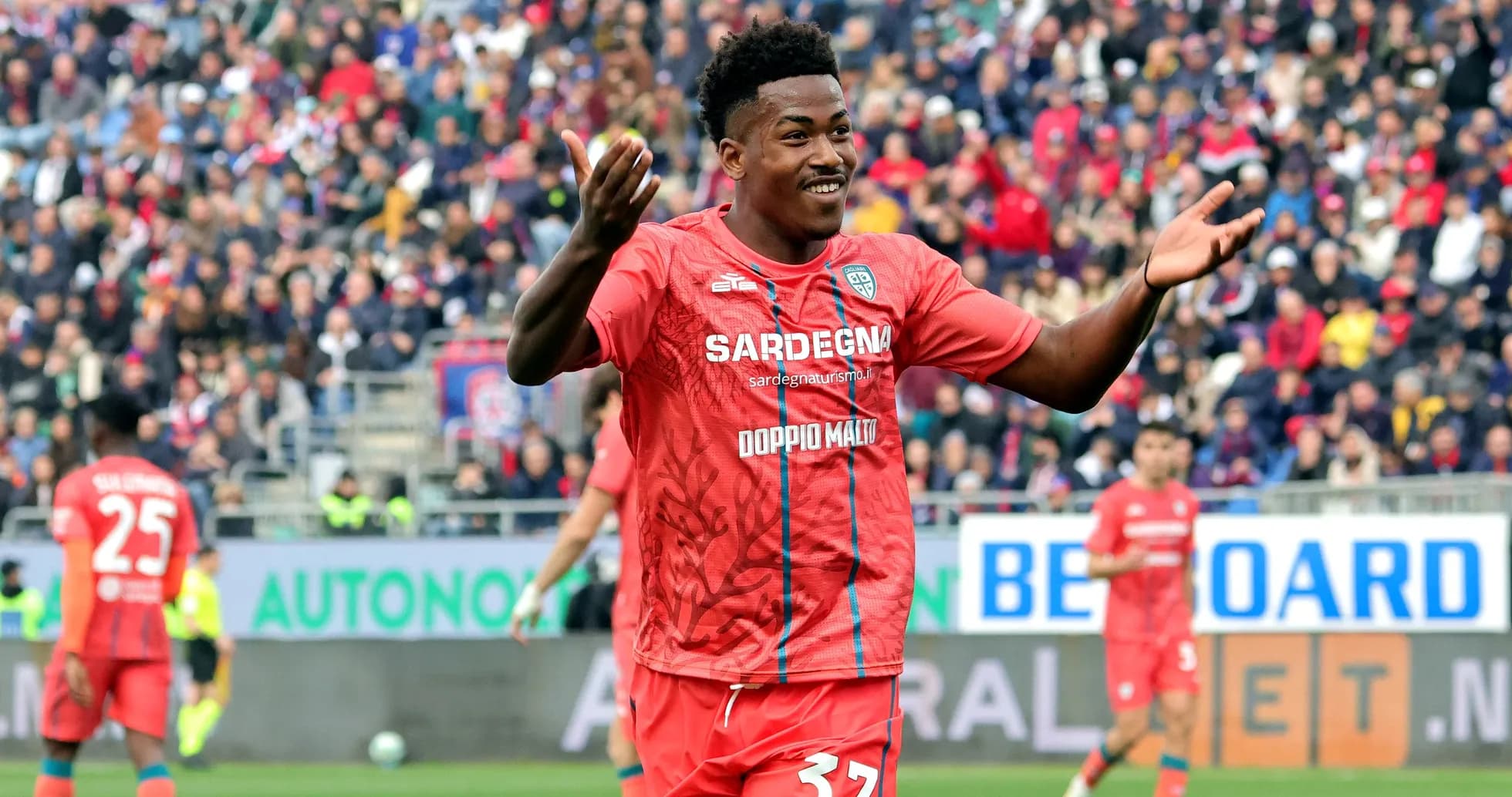 Player celebrating in red jersey during match Player celebrating in red jersey during match