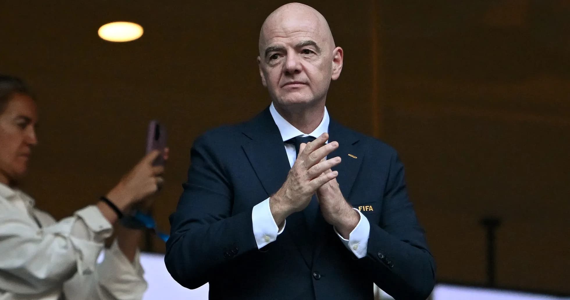 FIFA official clapping in a stadium box FIFA official clapping in a stadium box